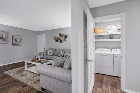 A living room with a grey couch and a coffee table.
