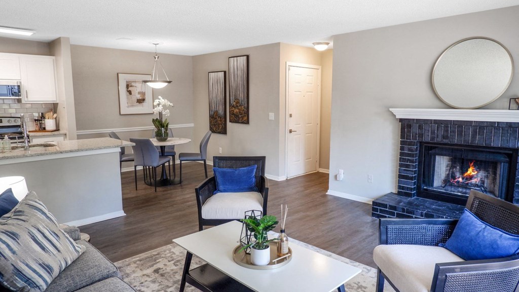 a living room with a fireplace and a table and chairs
