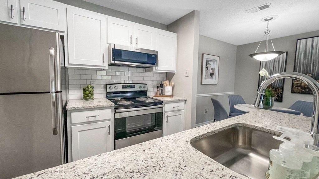 a kitchen with stainless steel appliances and granite counter tops