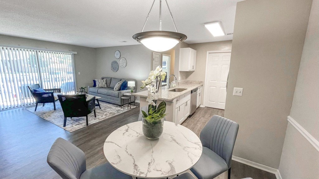 an open living room and dining room with a table and chairs