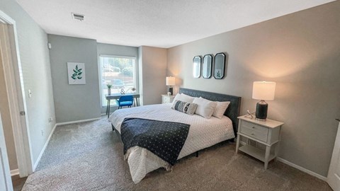 a bedroom with a large bed and a window