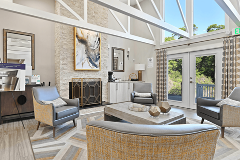 A living room with a grey couch and a brown chair.