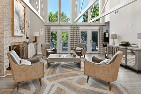 A living room with a fireplace and a large window.