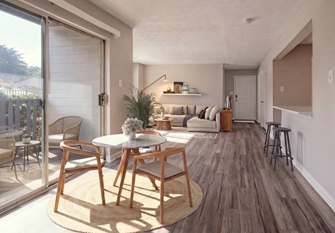 A modern living room with a dining table and chairs.