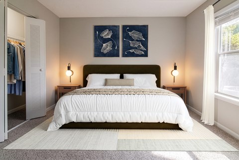 A bedroom with a large bed and two lamps on either side of the bed.