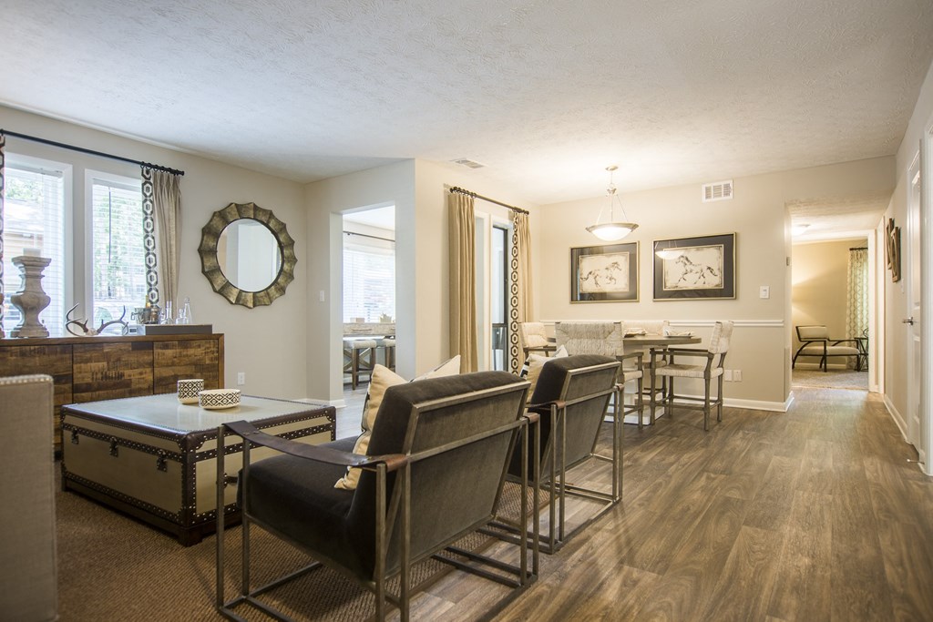 a living room and dining room with a table and chairs