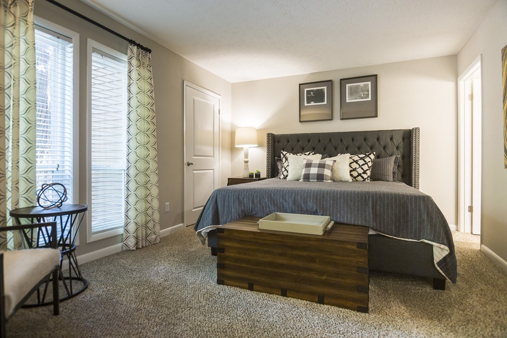 a bedroom with a large bed and a night stand