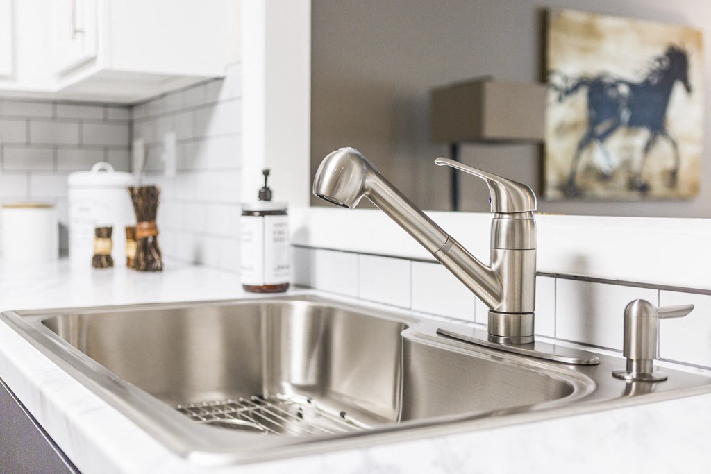 a stainless steel sink in a kitchen with a faucet