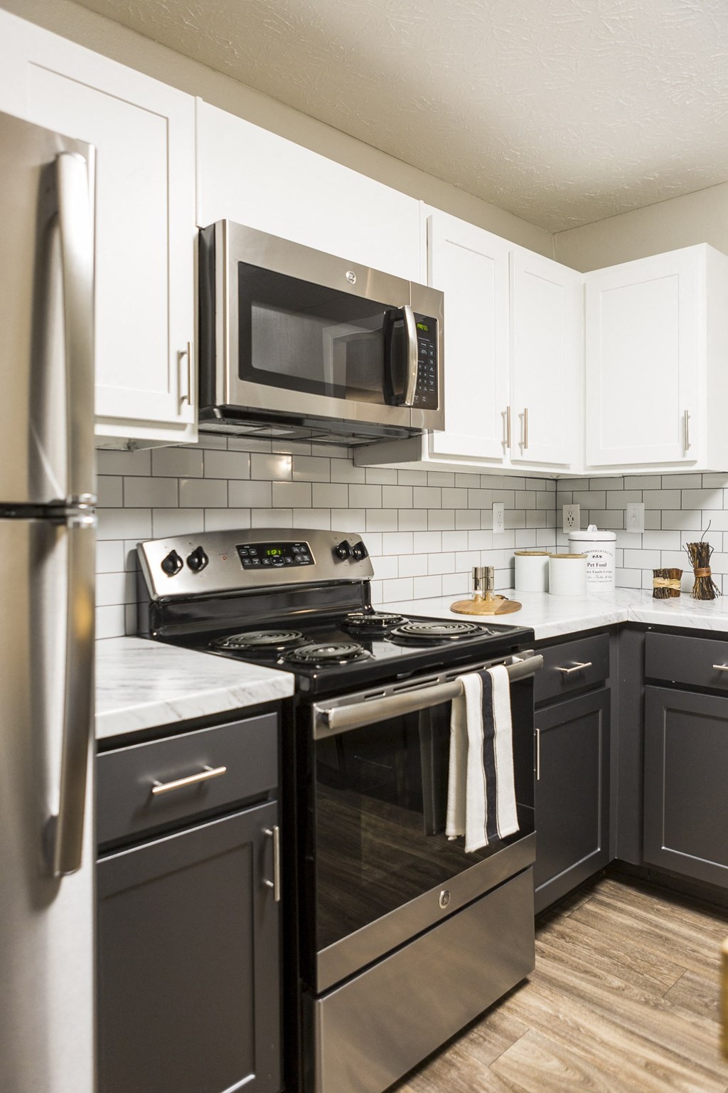 a modern kitchen with stainless steel appliances and white cabinets