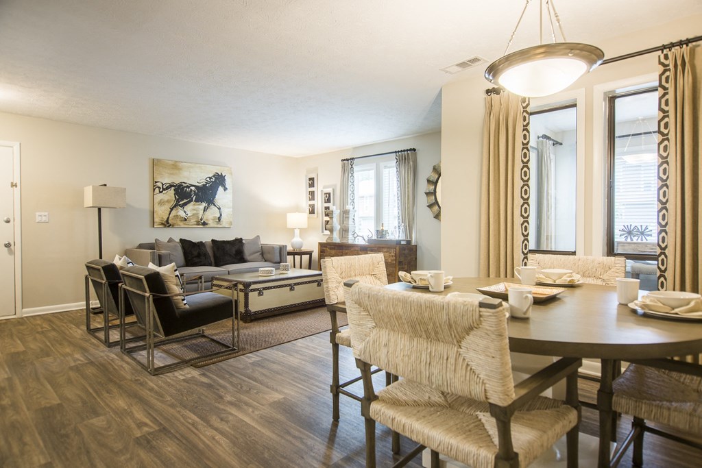 a living room and dining room with a table and chairs