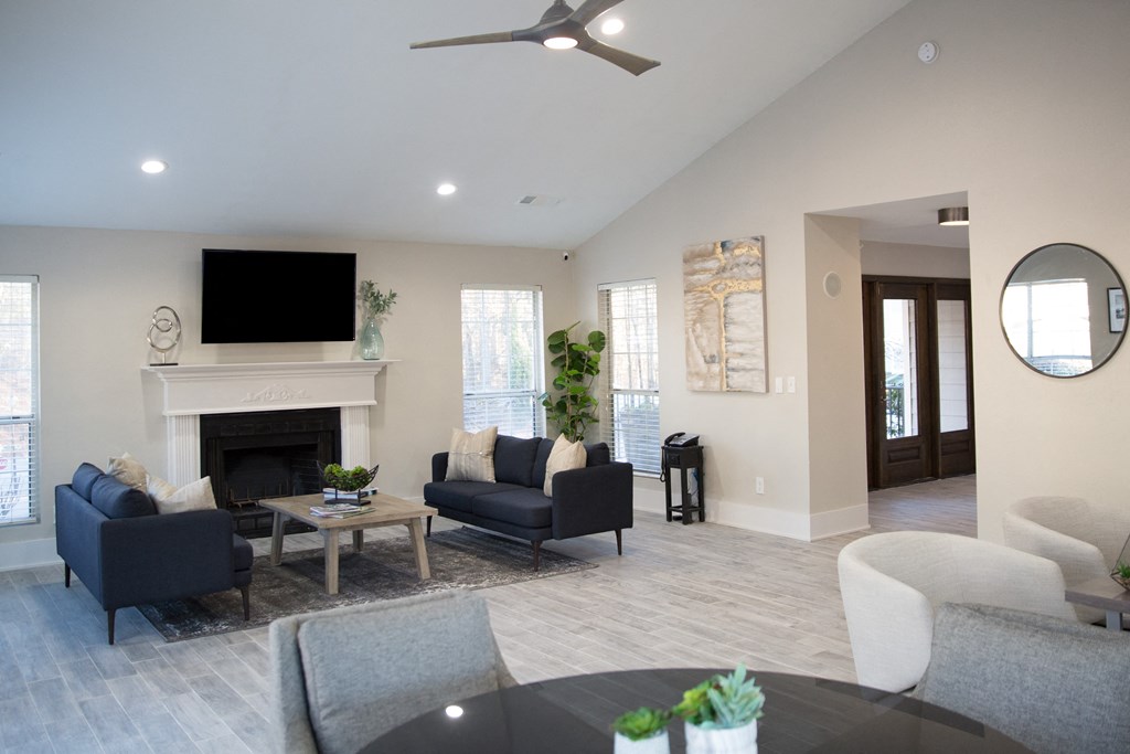 a living room with couches and chairs and a fireplace