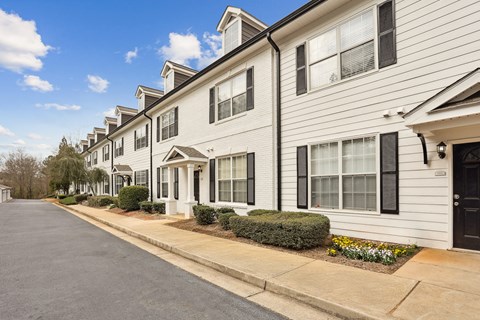 A row of houses with a street in between.