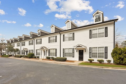 A row of townhouses with a clear blue sky above them.