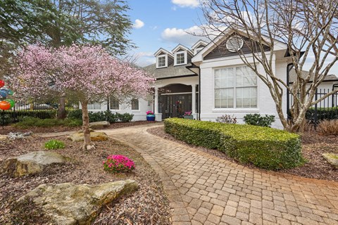 A house with a brick pathway leading to the front door.