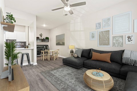 a living room with a couch and a ceiling fan