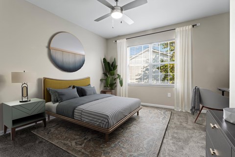 a bedroom with a bed and a ceiling fan