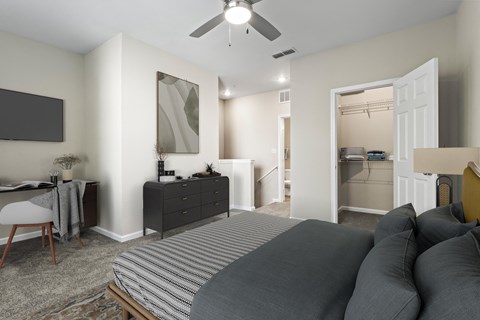a bedroom with a large bed and a ceiling fan