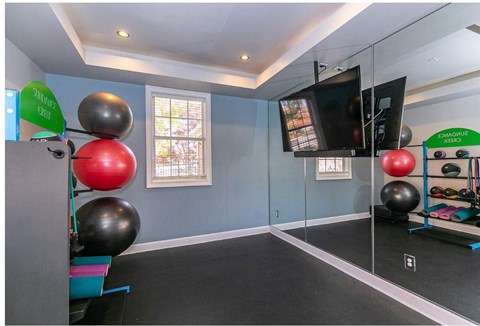 a home gym with balloons and a tv