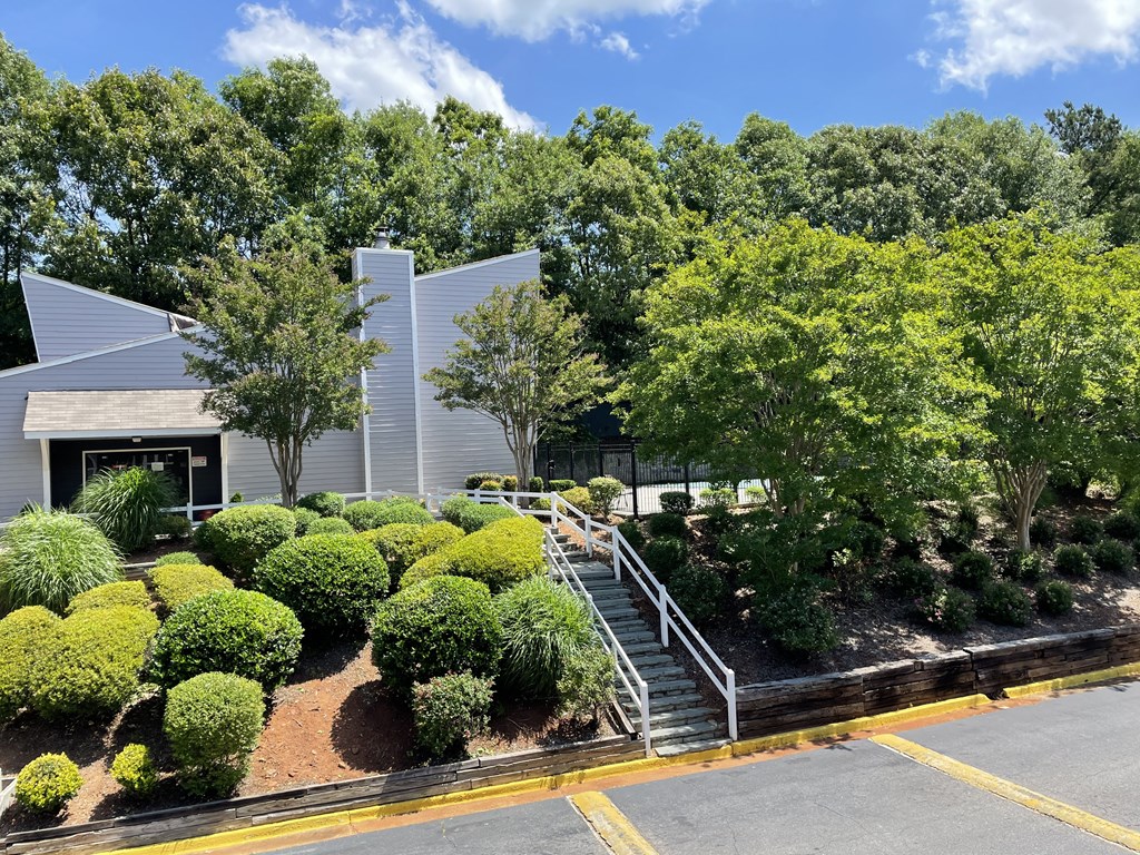 an exterior view of a building with a garden and stairs