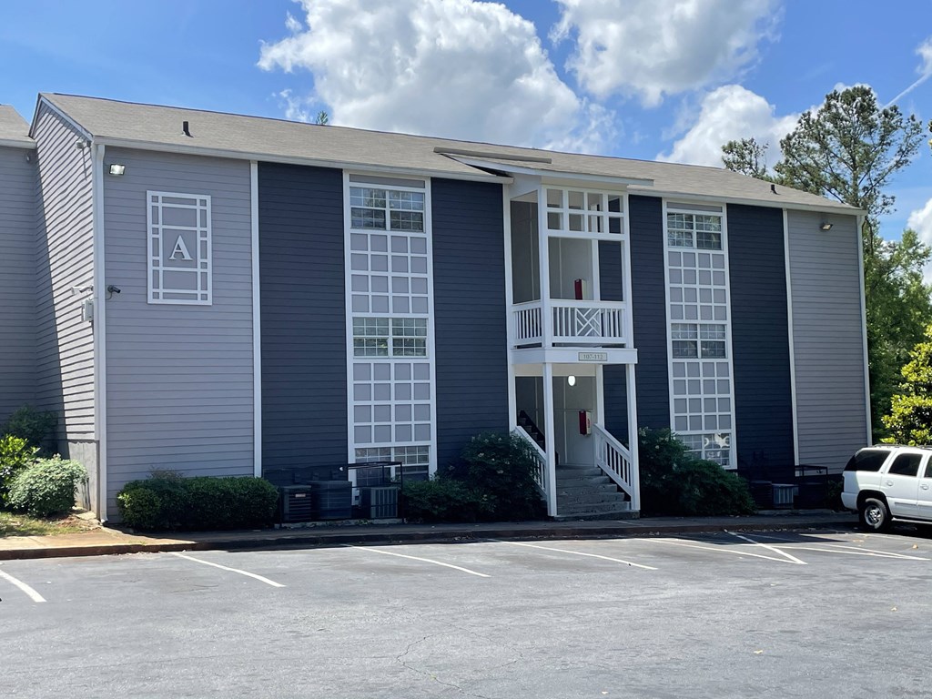 the outside of a building with a car parked in front of it