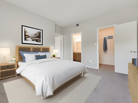 A bedroom with a large bed and a painting above it.