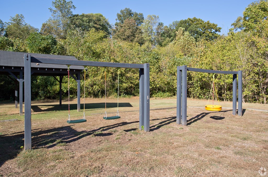 A playground with swings and a slide.