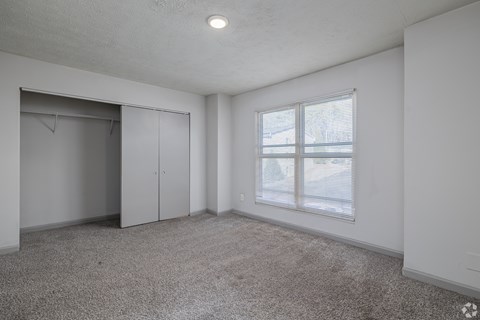 Empty room with a window and a door.