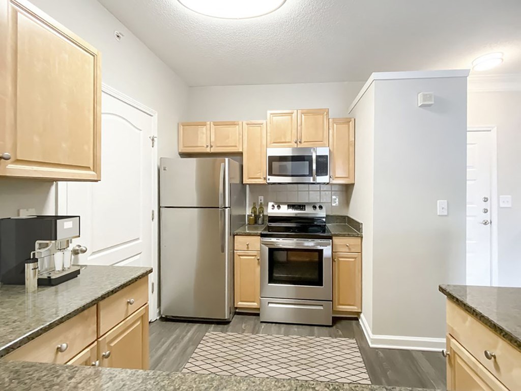 A kitchen with wooden cabinets and stainless steel appliances.