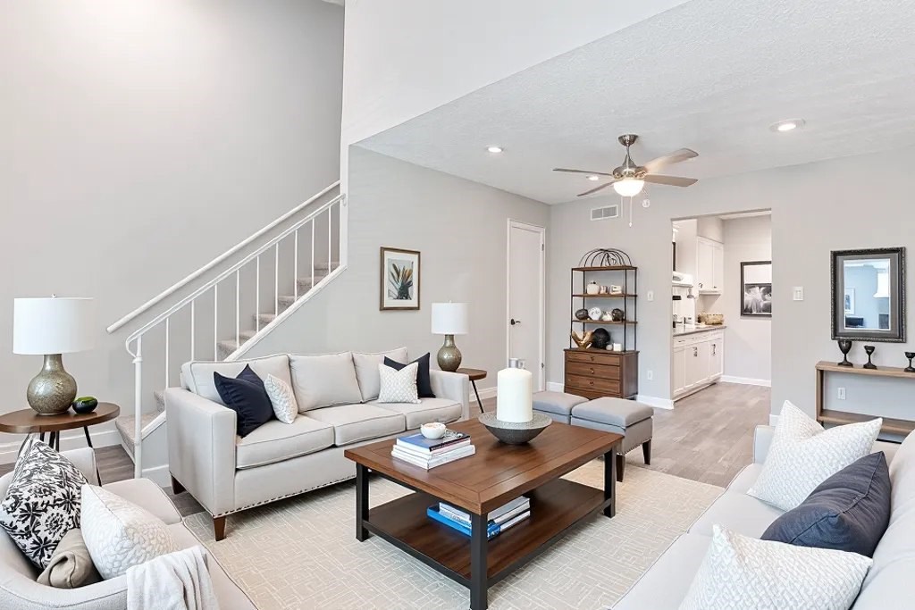 A living room with a white couch and a coffee table.