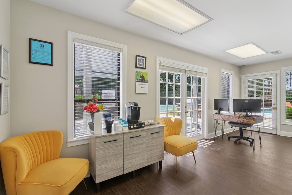 A yellow chair sits in a room with a desk and a computer.
