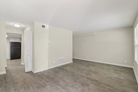 A room with light colored walls and a wood floor.