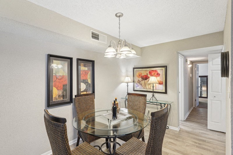 a dining room with a glass table and chairs