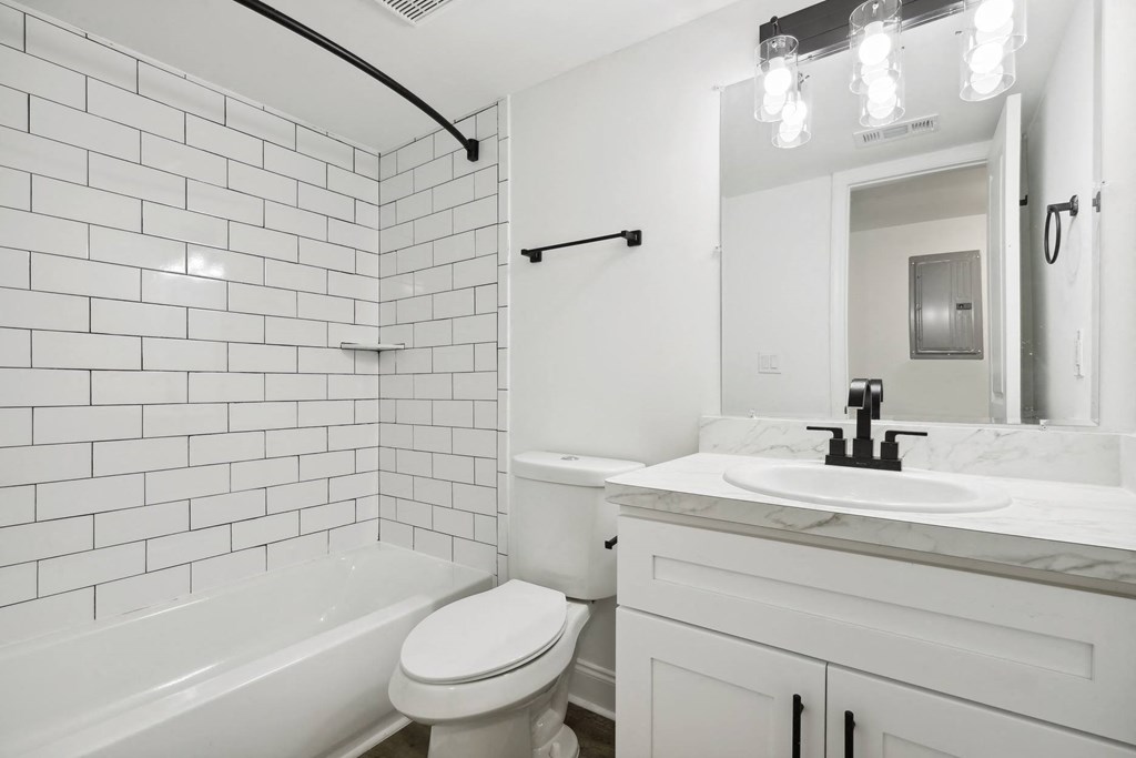 a white bathroom with a sink and a toilet