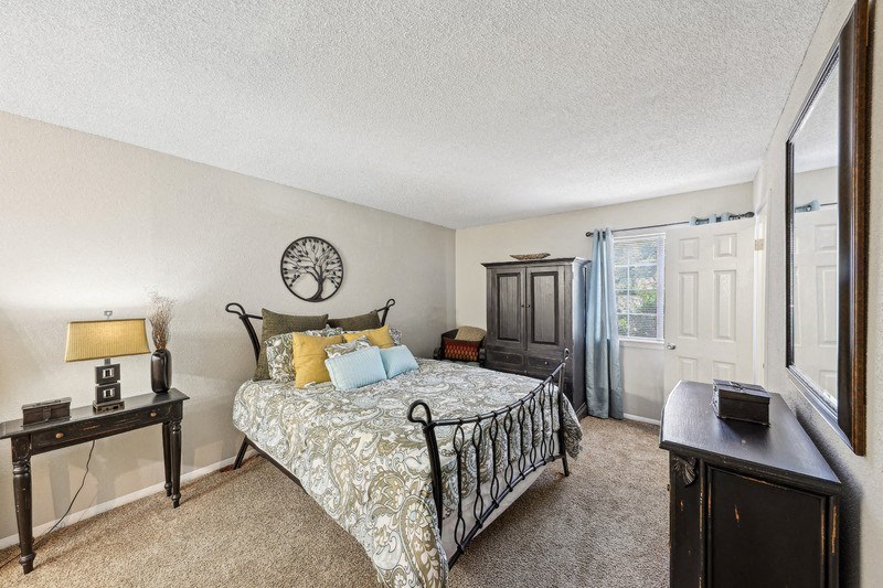 a bedroom with a bed and a window