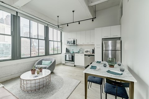 A modern kitchen with a dining table and chairs.at 1600 Callowhill, Philadelphia Pennsylvania