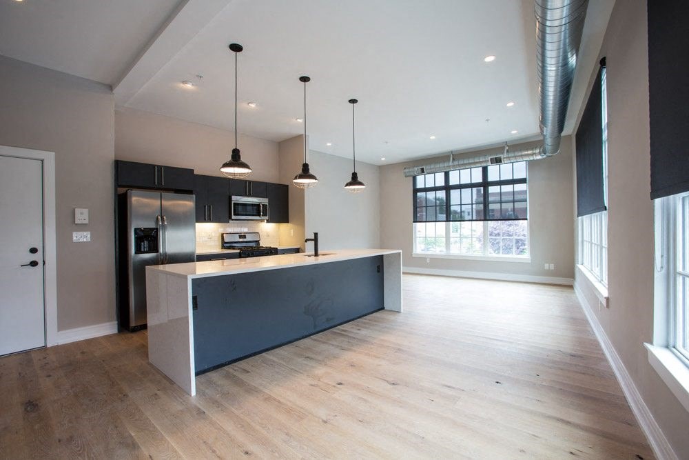 a large kitchen with a blue island in a large room