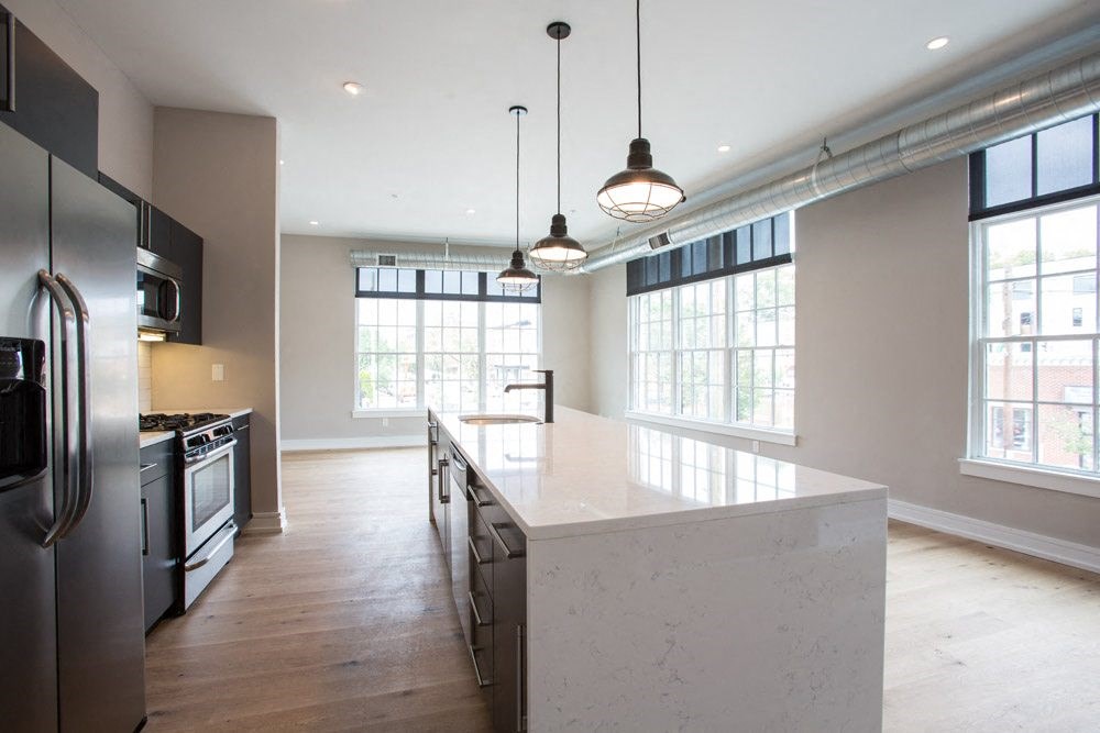 a large kitchen with an island and stainless steel appliances