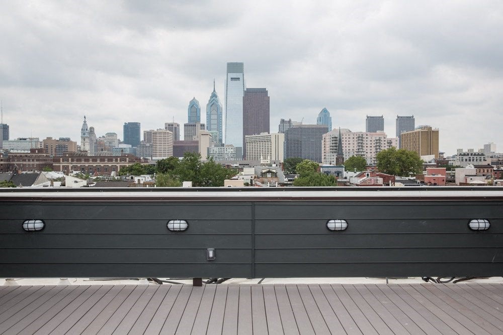 a bench with a city skyline in the background