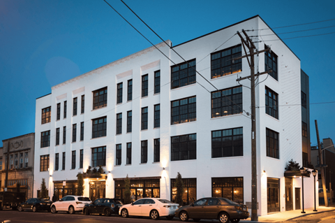 a large white building with cars parked in front of it