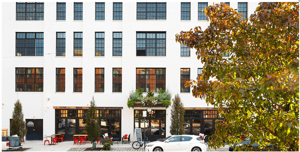 a white building with a white car in front of it