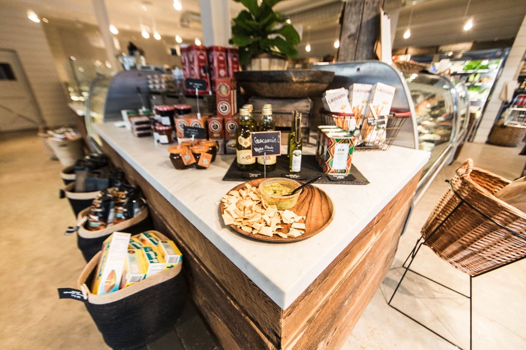 a counter with food and drinks on it in a store