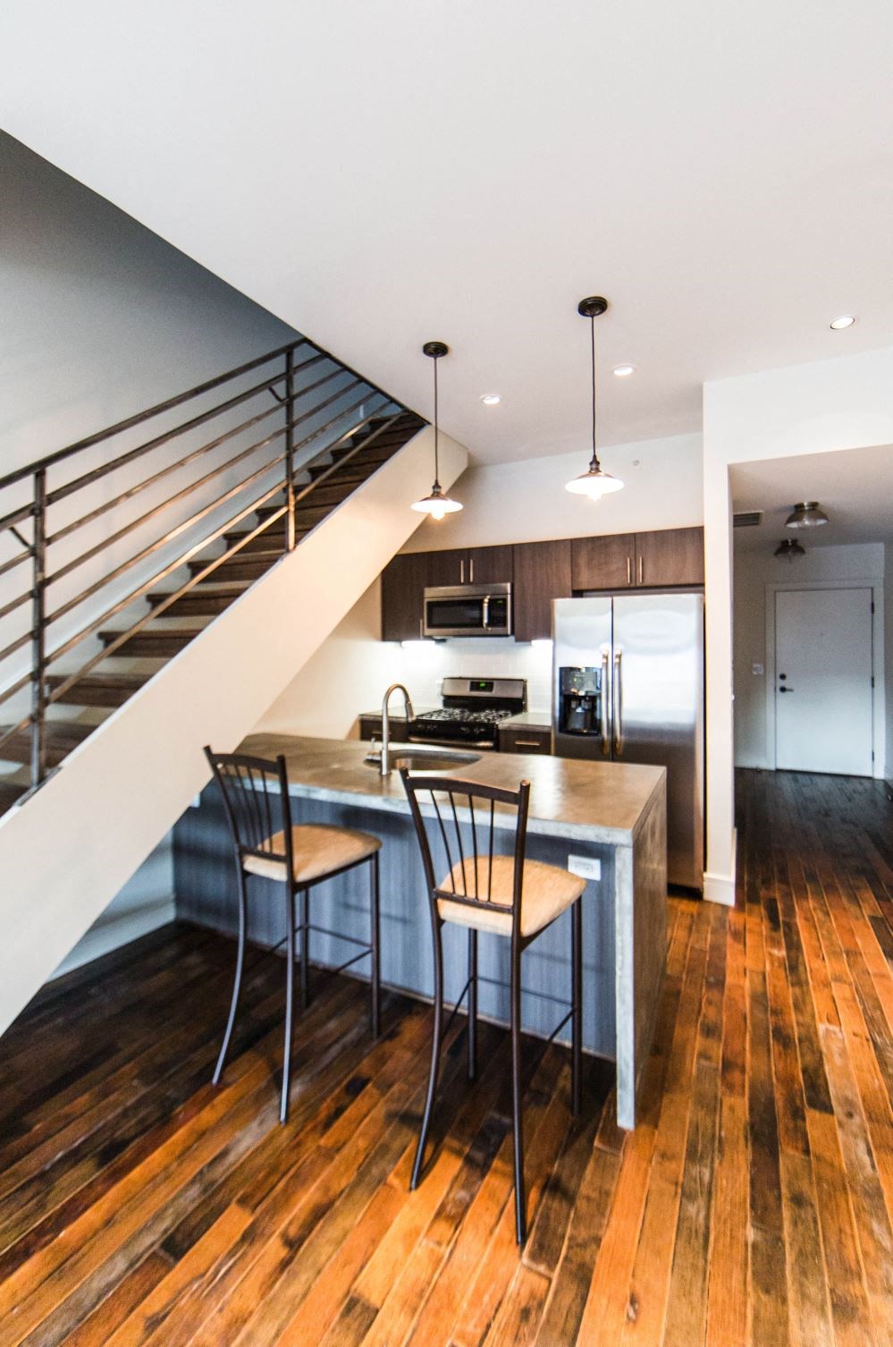 a kitchen with a counter top and a staircase