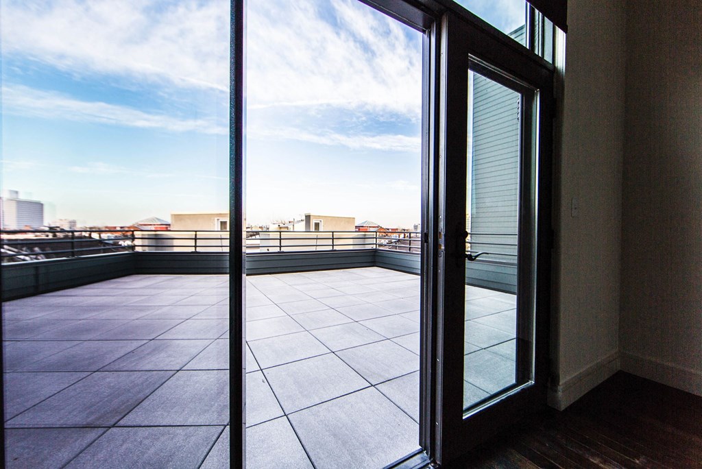 a balcony with a view of the city and the sky