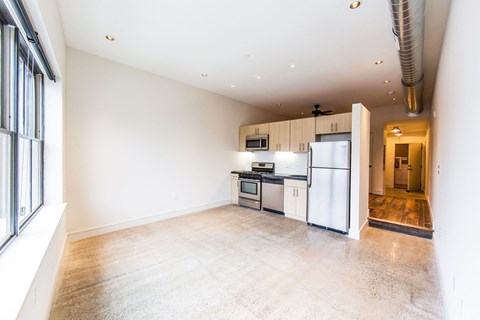 a kitchen with white cabinets and a white refrigerator