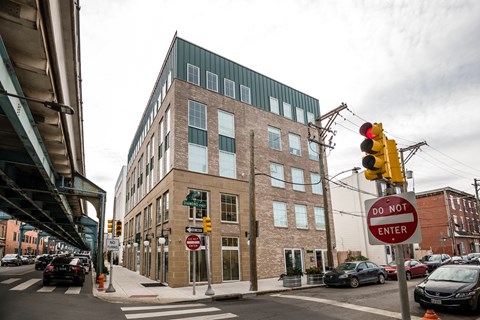 A building with a green awning and a red and white sign that says Do Not Enter.