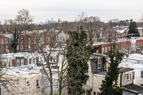 A view of a residential area with houses and trees.