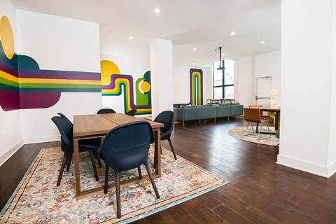 A dining room with a wooden table and chairs.