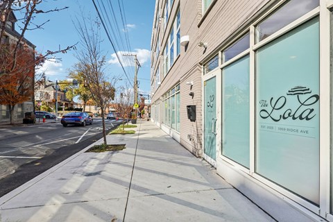 A street view of a building with a sign that reads "The Lola".