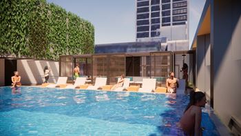 A pool with people in it and a green wall.