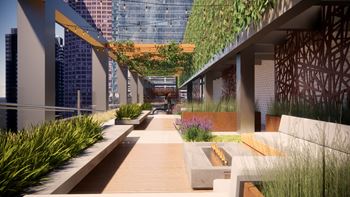 A modern outdoor walkway with benches and greenery.
